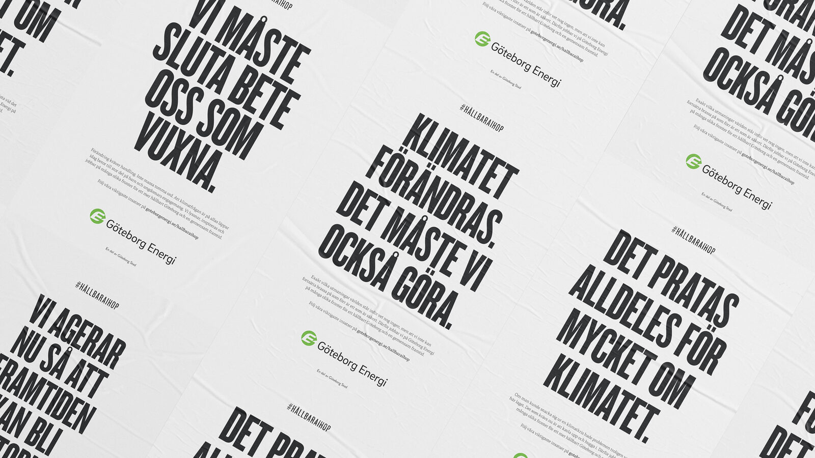 A wall papered with bold black-and-white Göteborg Energi climate posters – "Vi måste sluta bete oss som vuxna" among the headlines.