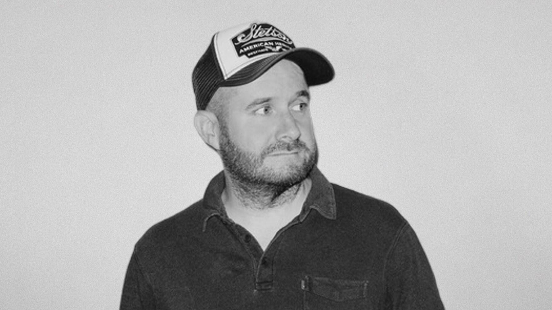 Black-and-white portrait of Kenneth Anderson, Copywriter at Stendahls, in a trucker cap.