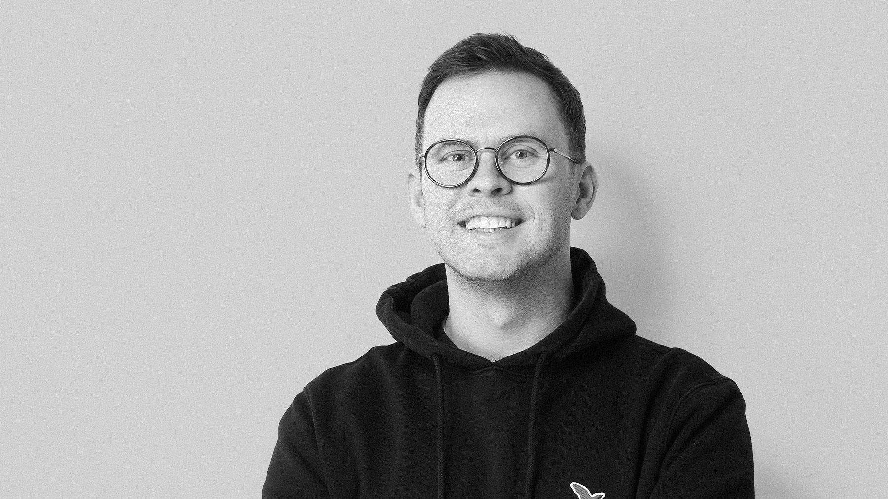 Black-and-white studio portrait of Oliver Rogers, Creative Director at Stendahls.
