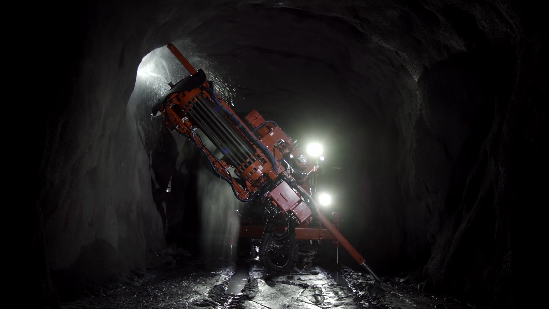 The Call to Inaction case film – a Sandvik drill rig at work in a dark mine tunnel under bright work lights.