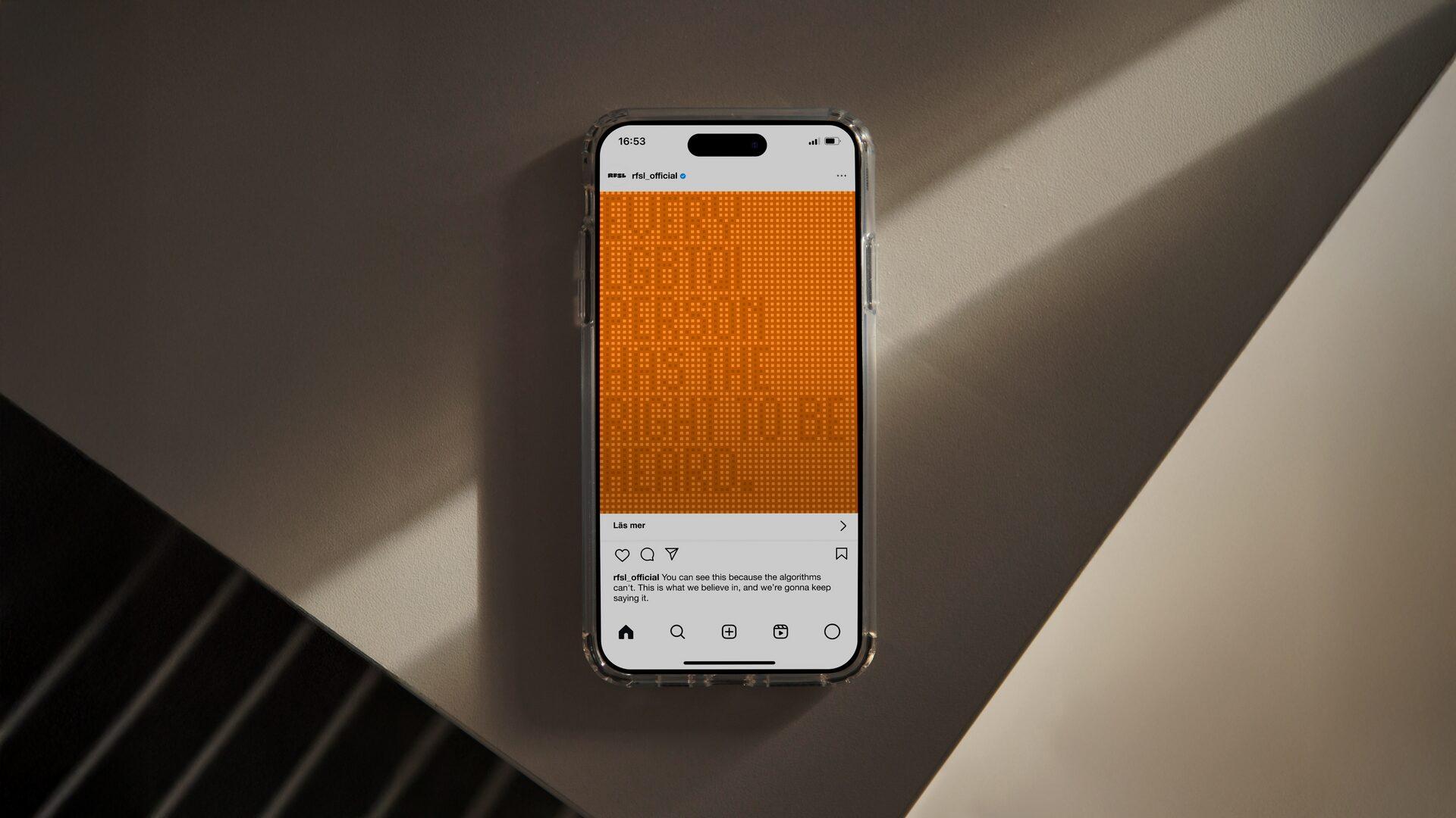 A phone screen on a desk showing an RFSL Instagram post – pixel-style poster reading "Every LGBTQI person has the right to be heard".