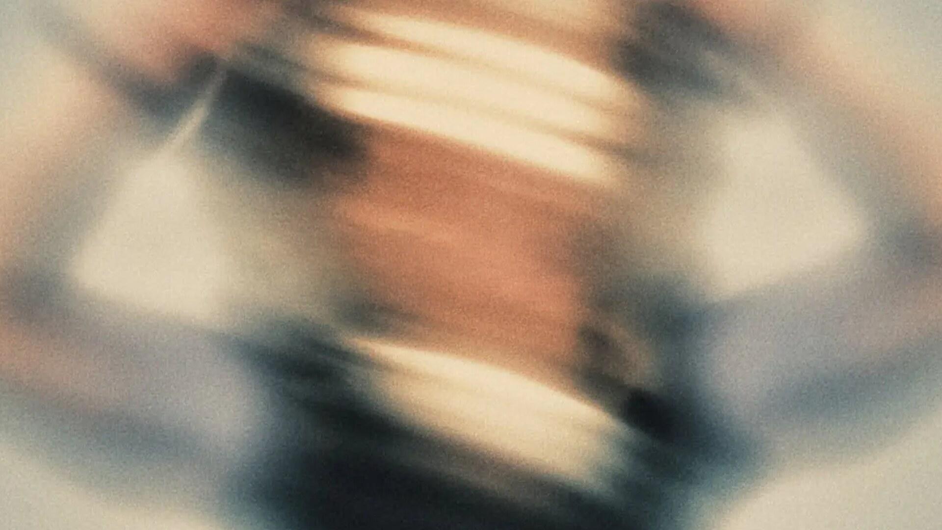 Blurred, grainy abstract photo in warm and cool tones.